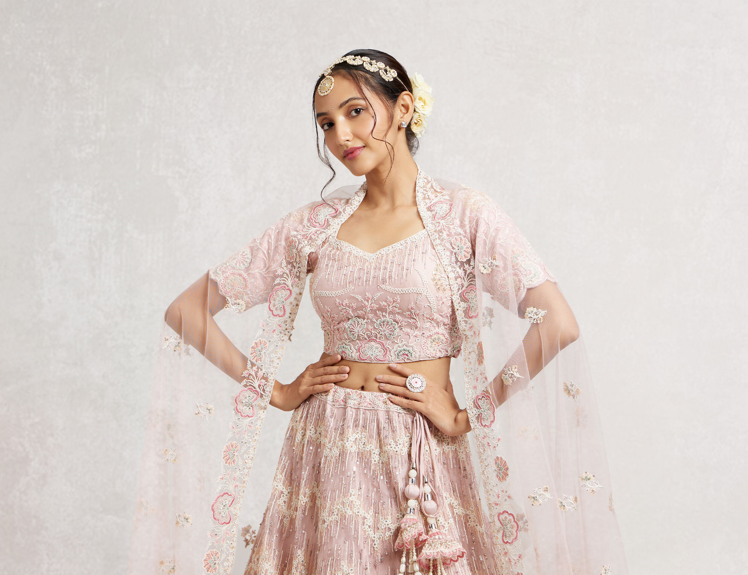 A bride in pink lehenga with round shape mangtikka 